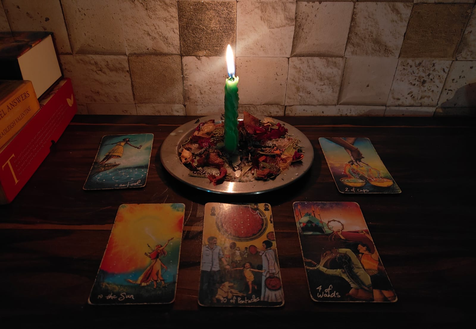 A softly lit tarot reading space with candles and cards